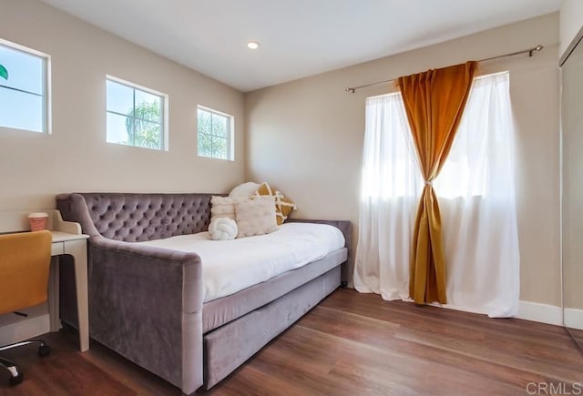 bedroom with dark wood-type flooring