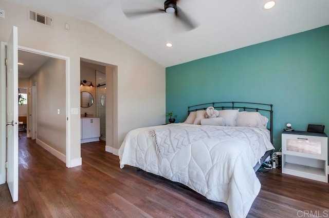 bedroom with vaulted ceiling, ceiling fan, dark hardwood / wood-style floors, and ensuite bath