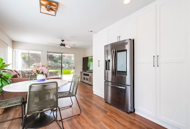 kitchen featuring ceiling fan, white cabinetry, stainless steel fridge, and wood-type flooring