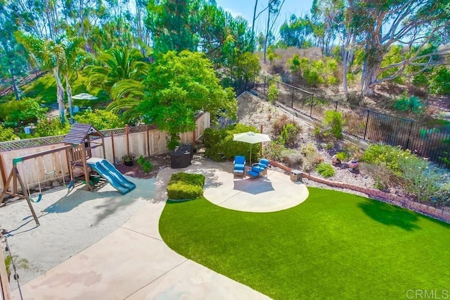 view of yard featuring a patio area and a playground