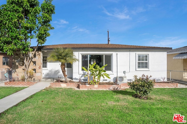 rear view of property featuring ac unit and a yard