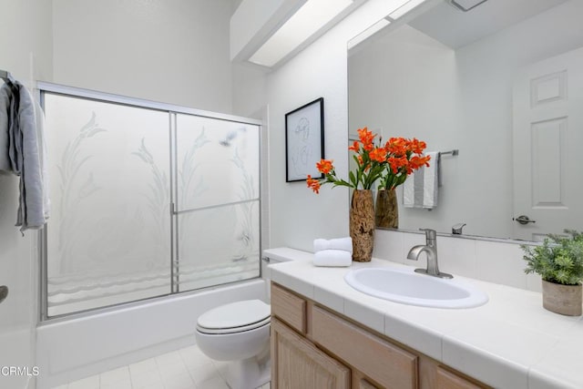 full bathroom featuring toilet, enclosed tub / shower combo, and vanity