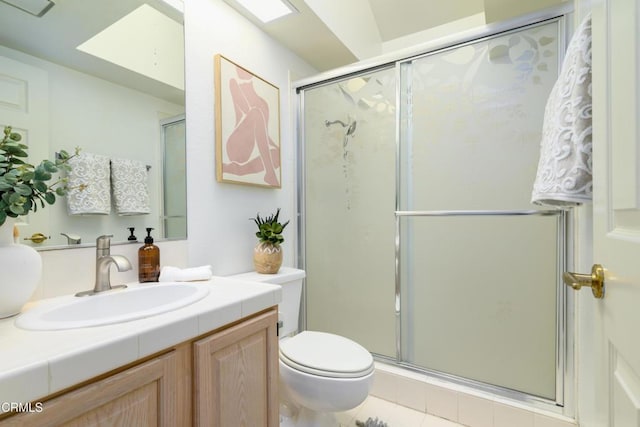 bathroom with walk in shower, vanity, and toilet