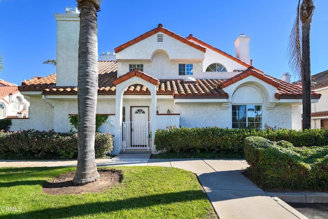 mediterranean / spanish-style home featuring a front lawn