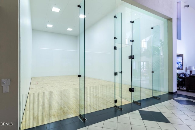 interior space featuring an enclosed shower and tile patterned floors