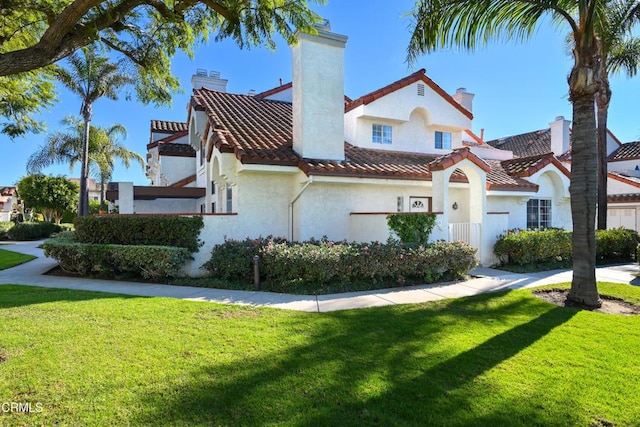 mediterranean / spanish-style home with a front lawn