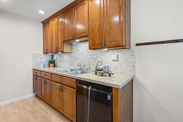 kitchen with dishwasher, decorative backsplash, sink, and light hardwood / wood-style flooring