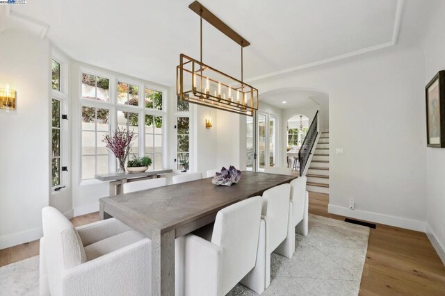 dining room with a notable chandelier and light hardwood / wood-style floors