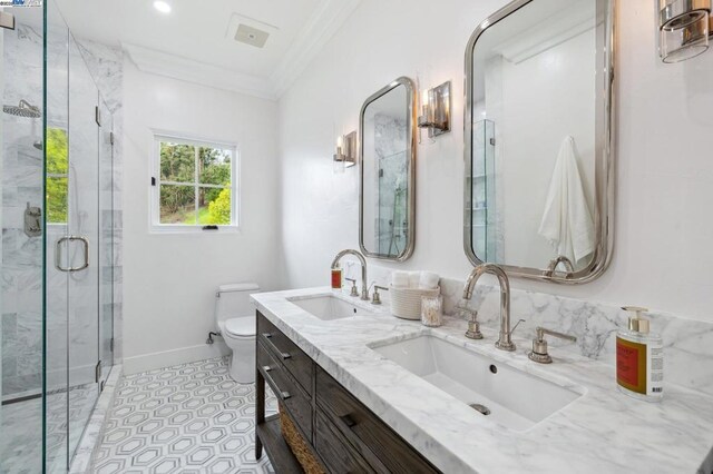 bathroom with toilet, a shower with door, crown molding, and vanity