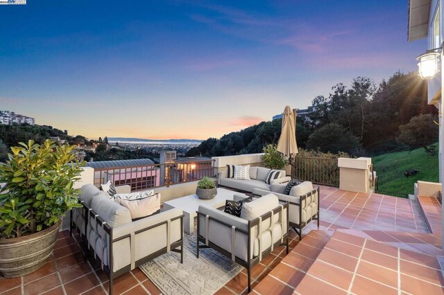 patio terrace at dusk featuring an outdoor hangout area