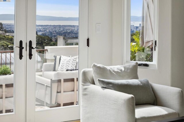 interior space with french doors, plenty of natural light, and a mountain view