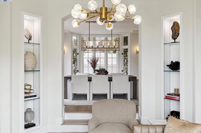 dining room featuring built in features and a notable chandelier