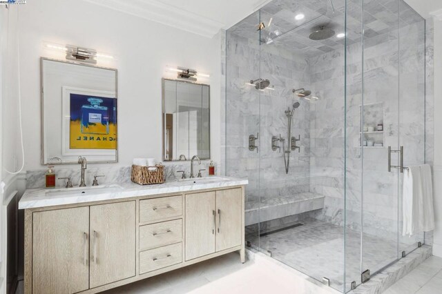 bathroom with an enclosed shower, vanity, and crown molding