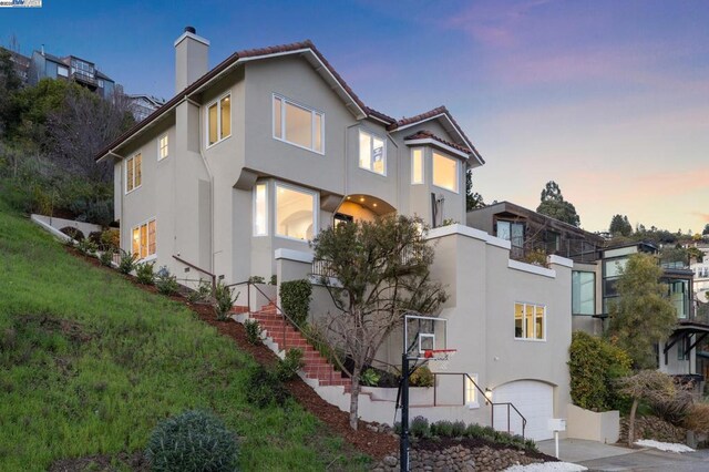 property exterior at dusk featuring a garage