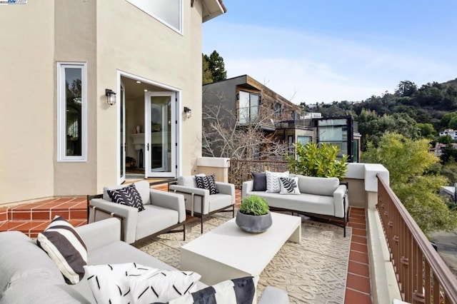 view of patio featuring an outdoor living space and a balcony