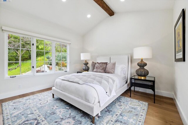 bedroom with hardwood / wood-style floors and lofted ceiling with beams