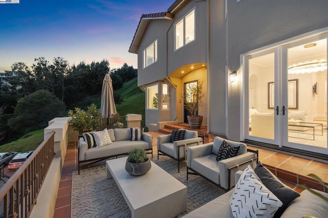 patio terrace at dusk with french doors and outdoor lounge area