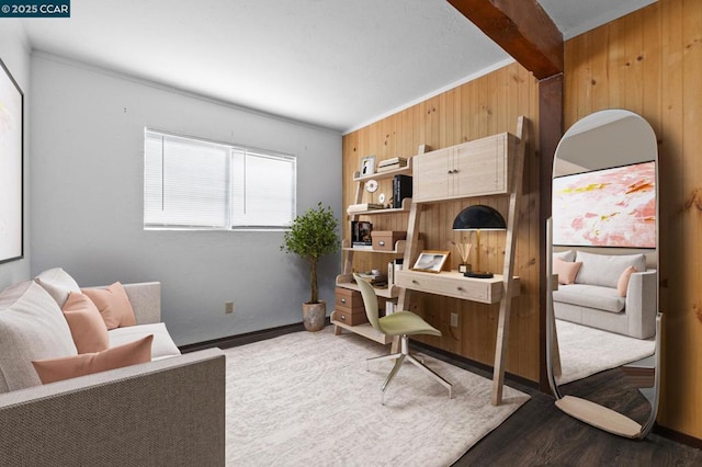 living area with wood walls, dark hardwood / wood-style floors, and beam ceiling