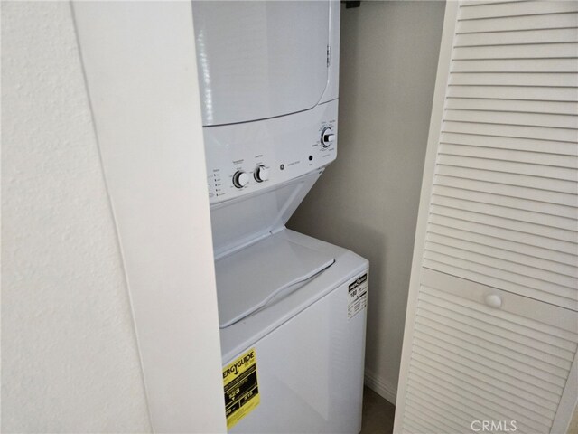 laundry area with stacked washer / drying machine