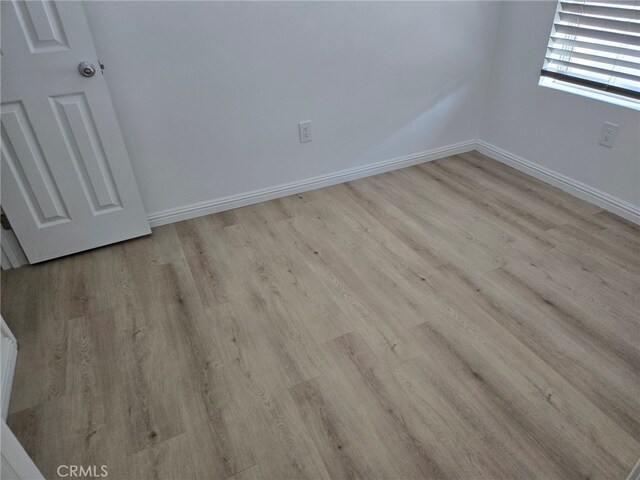 spare room featuring light wood-type flooring