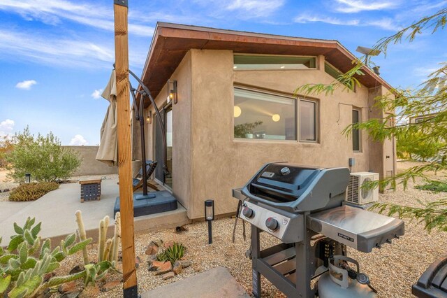 view of side of home featuring ac unit