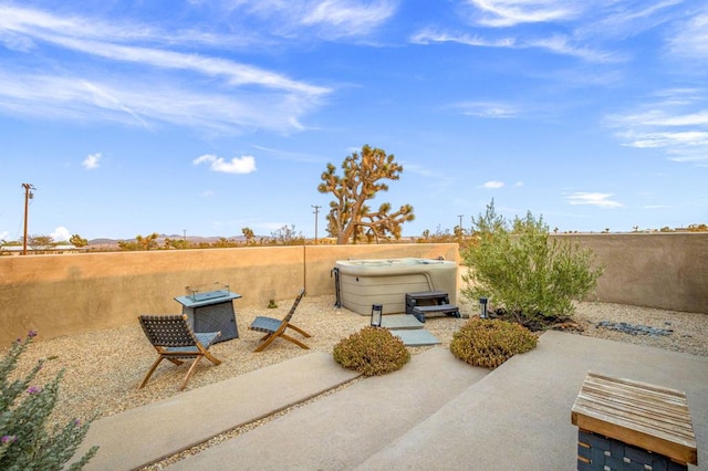 view of patio / terrace with a hot tub