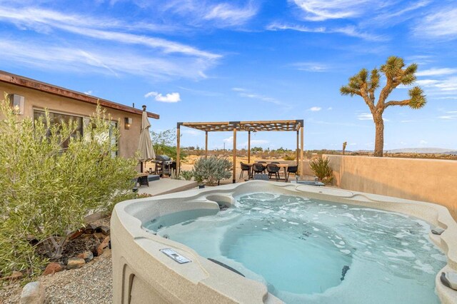 view of swimming pool featuring a patio area, a hot tub, and grilling area