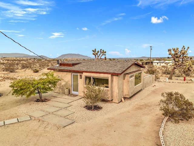 back of property featuring a mountain view