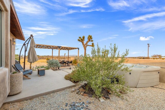 view of patio / terrace with a hot tub