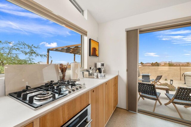 kitchen with wall oven and stainless steel gas cooktop