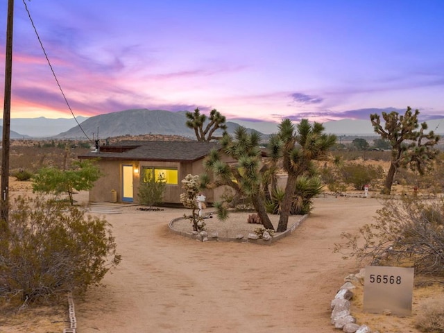 back house at dusk featuring a mountain view