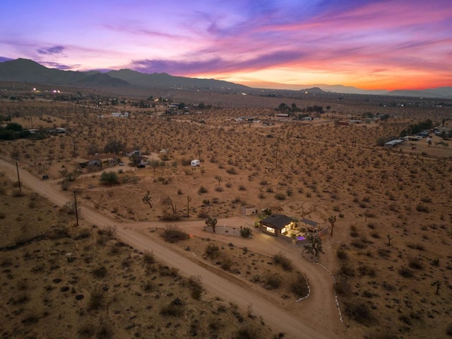 aerial view at dusk featuring a mountain view