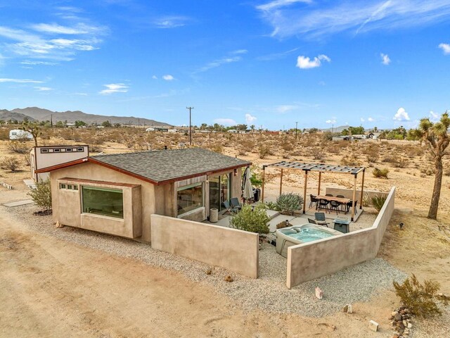 rear view of property with a mountain view and a pergola