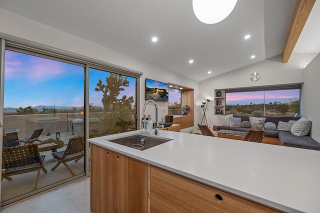 kitchen featuring vaulted ceiling with beams and sink