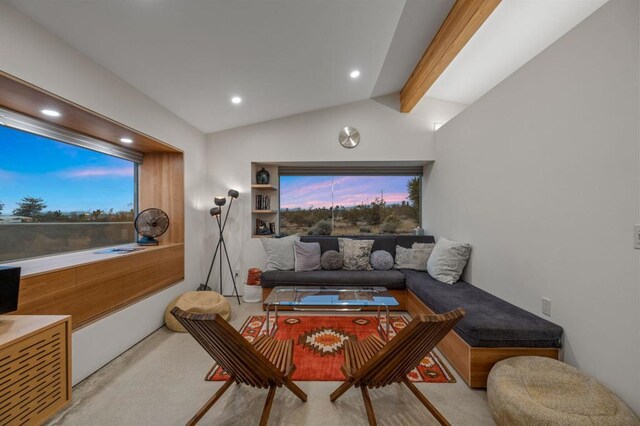 cinema room featuring built in features and vaulted ceiling with beams