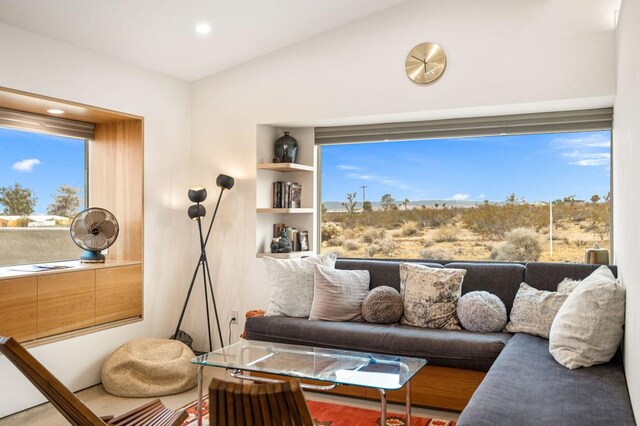 living room featuring lofted ceiling and plenty of natural light