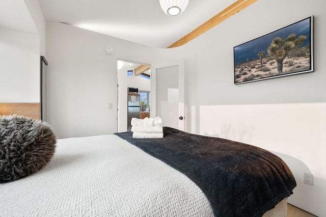 bedroom with vaulted ceiling with beams