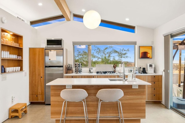 kitchen with vaulted ceiling with beams, stainless steel fridge, a breakfast bar, and a center island