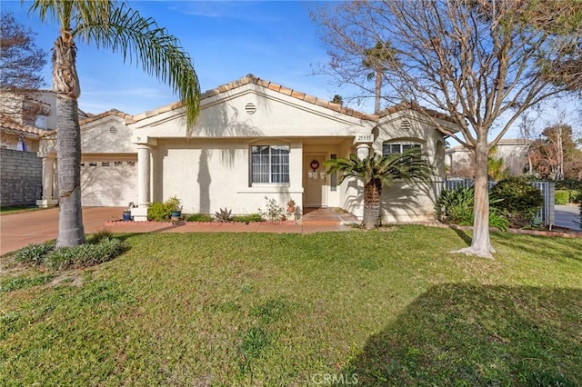 mediterranean / spanish home featuring a front yard and a garage