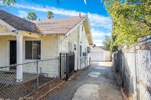 view of side of property featuring a garage and an outbuilding