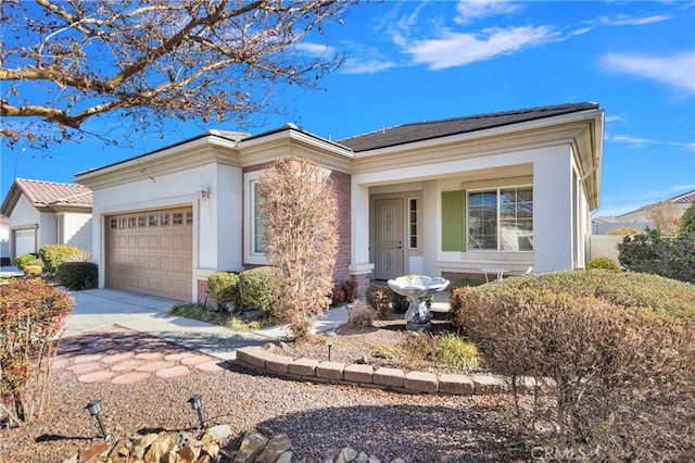 19269 Galloping Hill Rd, Apple Valley, CA 92308 - view of front of house featuring stucco siding, a garage, and concrete driveway