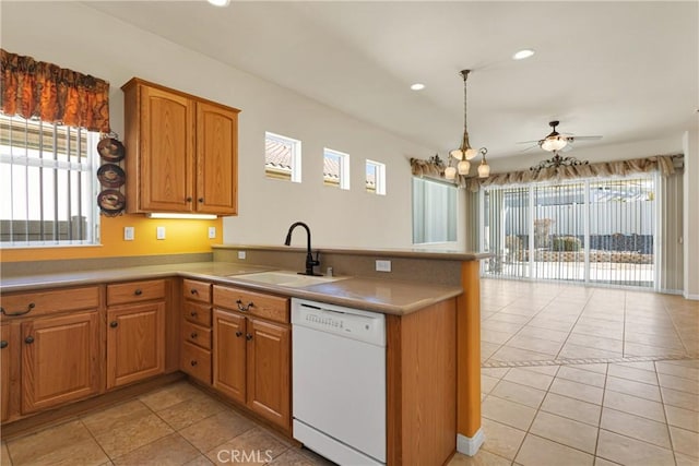 19269 Galloping Hill Rd, Apple Valley, CA 92308 - kitchen with white dishwasher, a sink, a peninsula, light tile patterned floors, and brown cabinets