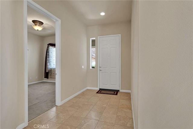 view of carpeted foyer entrance