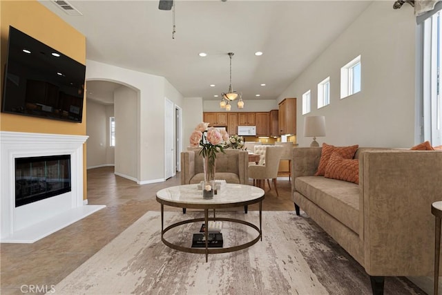 tiled living room with a chandelier