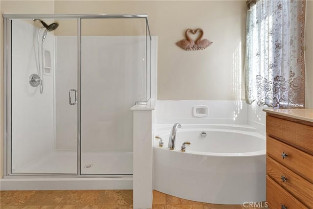 bathroom with vanity and independent shower and bath