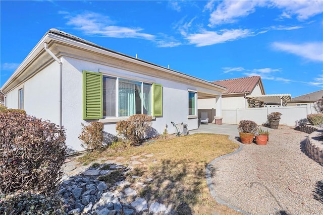 19269 Galloping Hill Rd, Apple Valley, CA 92308 - view of side of home featuring a patio area, fence, and stucco siding