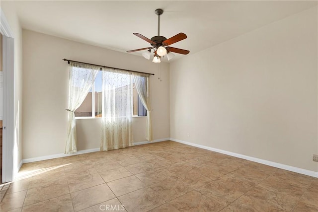 tiled spare room with ceiling fan