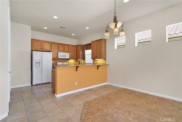 19269 Galloping Hill Rd, Apple Valley, CA 92308 - kitchen with white appliances, recessed lighting, a peninsula, healthy amount of natural light, and a breakfast bar area