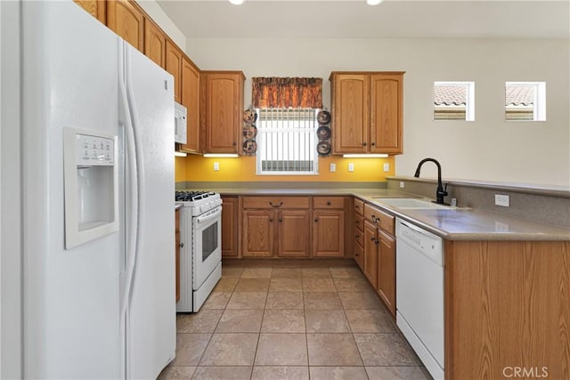 19269 Galloping Hill Rd, Apple Valley, CA 92308 - kitchen featuring white appliances, a sink, a peninsula, and brown cabinetry