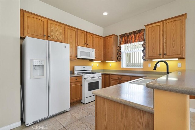 19269 Galloping Hill Rd, Apple Valley, CA 92308 - kitchen with white appliances, a sink, a peninsula, brown cabinetry, and recessed lighting